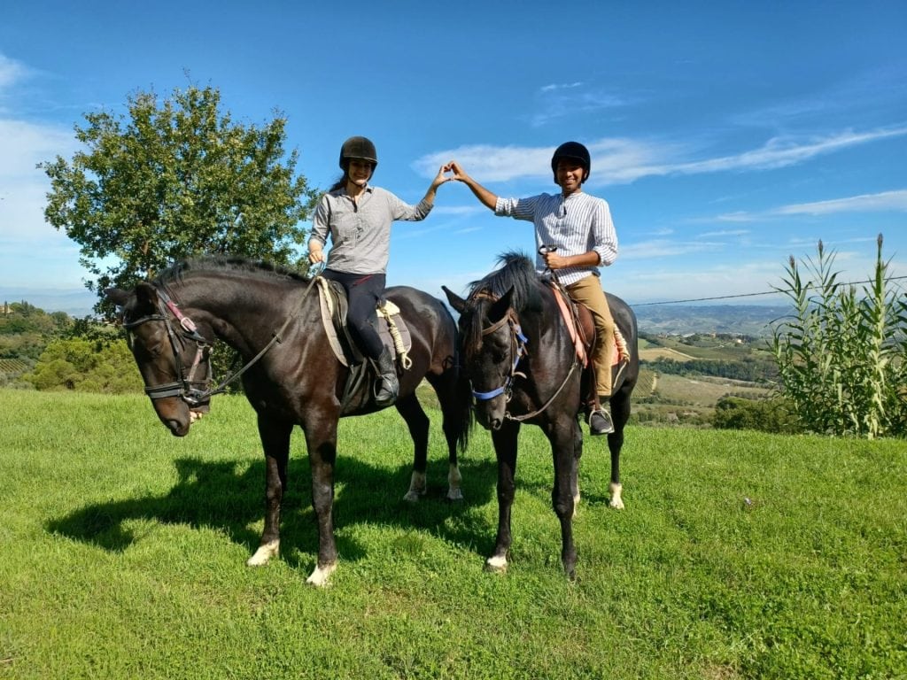 Couple Having A Horseback Riding Tour In Tuscany